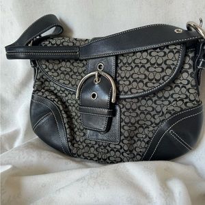 Coach small flap handbag with snap closure and buckle exterior design